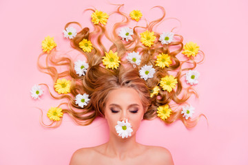 Close up top above high angle view photo beautiful she her lady hide mouth lips not speak tell talk lying down flowers long curly wavy great way washing hair eyes closed isolated pink background