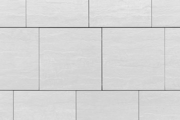 Large grey tile pattern surface on wall, background close-up