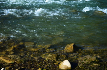 View of a mountain river with clear emerald water