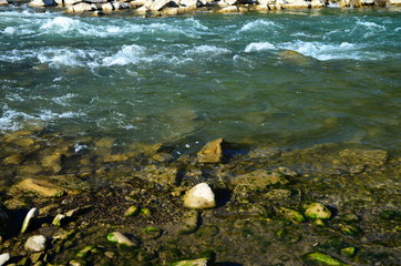View of a mountain river with clear emerald water