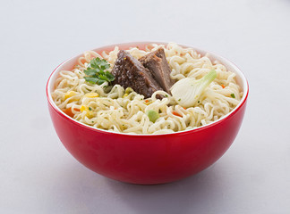 instant noodles with meat in a red bowl, insulated. fast food