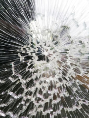 Glass with cracks due to radial breakage from an impact in the center 