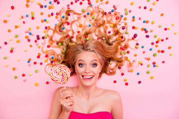 Obraz na płótnie Canvas Close up top above high angle view photo amazing she her lolly pop lollypop hand arm lady lying down sweets ideal hair tongue out mouth crazy wearing dress isolated rose pink background