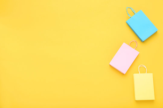 Small Paper Shopping Bags On Yellow Background