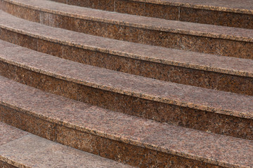 Crescent tiled stairs leading to building bottom view.