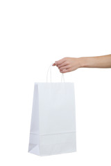 Female hand holding shopping bag on white background
