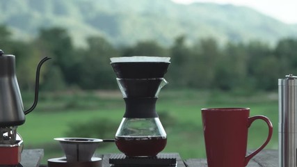 drip coffee with filter in morning on beautiful rice fields view.