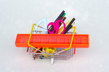 shopping basket full of school supplies