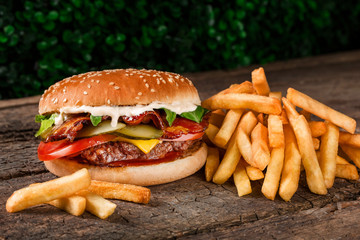 cheeseburger with fries on a wooden board