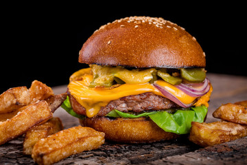 cheeseburger with fries on a wooden board