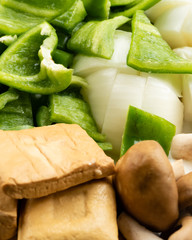 Green peppers, tofu, onion, and mushrooms in plate