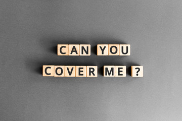 Can you cover me? - phrase from wooden blocks with letters, mutual assistance companionship concept, grey background