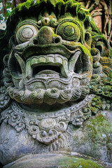 moss covered Bali god face stone statue, Bali island