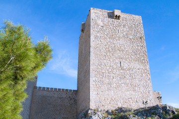 Tower of  white castle and wall. Jaen. Spain