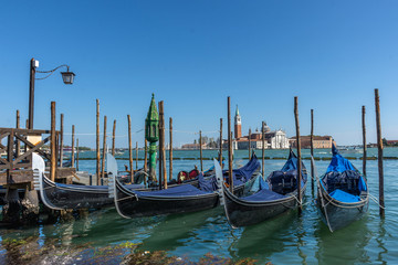 Fototapeta na wymiar Gondolas near Saint Mark square (San Marco) and San Giorgio di Maggiore church in the background, in Venice, Italy