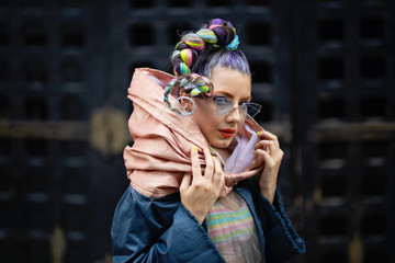Street fashion 2020 - Eccentric woman model  with dreadlocks, piercings and avantgarde look
