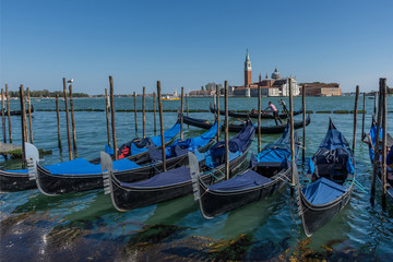 Gondolas near Saint Mark square (San Marco) and San Giorgio di Maggiore church in the background, in Venice, Italy