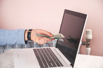 business man hand money on computer