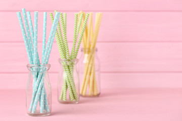 Colorful paper straws on pink background
