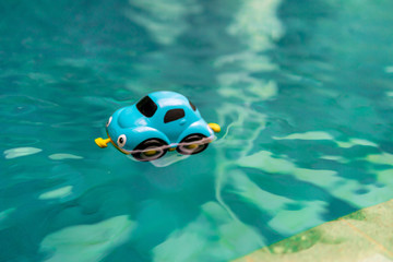 Fototapeta na wymiar a toy car floating in a clear swimming pool