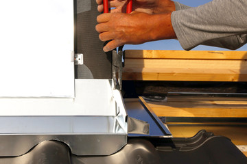 Roofer working on exterior chimney cladding