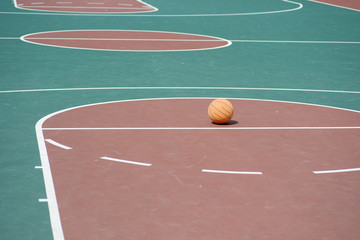 Fototapeta premium Basketball on empty basketball court