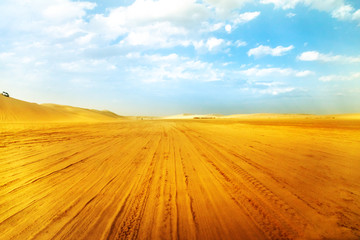 Fototapeta na wymiar Desert landscape sand dunes at sunset sky near Qatar and Saudi Arabia. Khor Al Udeid, Persian Gulf, Middle East. Discovery and adventure travel concept.