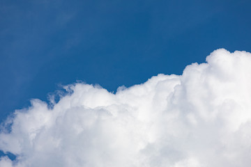 Naklejka na ściany i meble Fluffy cloud edge and blue sky