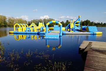Floating inflatable castle on lake with reflection