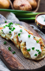 Potato pancakes with dill on rustic wooden cutting board