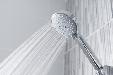 Bathroom shower head spraying water  - obrazy, fototapety, plakaty