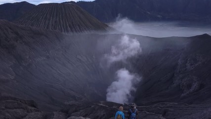 AERIAL: A hikers walks at the edge of Bromo volcano in Java island, Indonesia