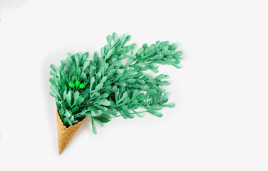Green leaves in in ice cream cone.