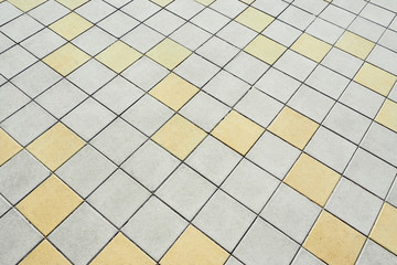 Abstract background and texture of a street square tile. Bridge. Gray and yellow squares...