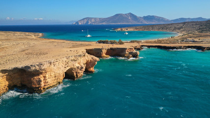 Obraz premium Aerial drone photo of iconic caves of Xylobatis or Ksylompatis in Koufonisi island, Small Cyclades, Greece