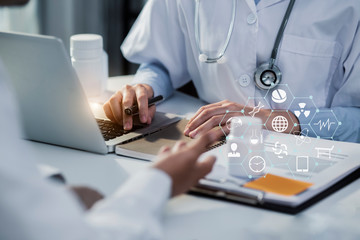 Doctor and patient discussing something while sitting at the table 