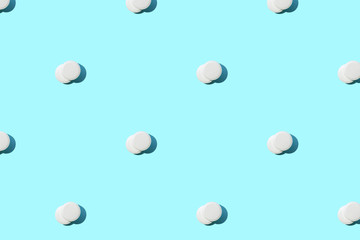 Pattern made of a lot of white round pills on blue.