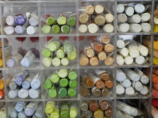 set of colorful pastels in a plastic box. objects for drawing. creativity. goods for artists. distribution by color tones.