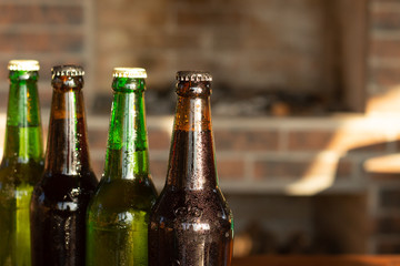top part of green and brown beer bottles closeup