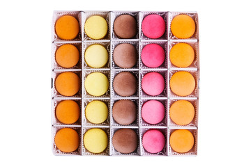 Set of colorful macaroons in the box on isolated white background. The view from the top.Fresh multi-color macaroons.