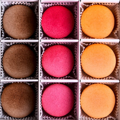 Set of colorful macarons in the box. The view from the top.Fresh multi-color macarons or macaroons