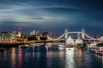 View to tke skyline of London, UK, during night time over the Thames river to the Tower Bridge and Canary Wharf district