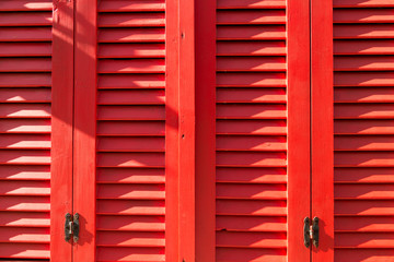 Fototapeta na wymiar The red colorful shutter background.