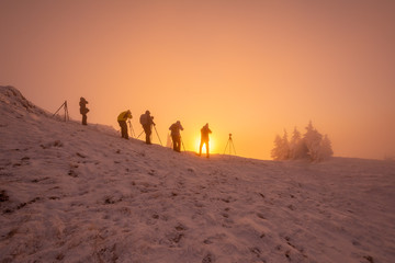Group of photographers at sunrise on a cold December morning