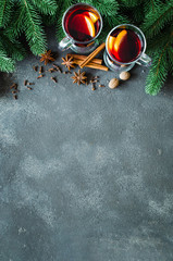 Christmas mulled red wine with spices on dark concrete background