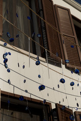 the many evil eye beads near the window.