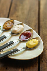 Sauces in portioned cutlery, serving appetizer (different varieties) menu concept. food background. copy space