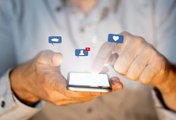 Man using smartphone on social media with notification icons