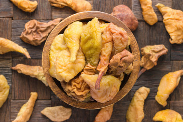 dried pears in wooden bowl, top view.