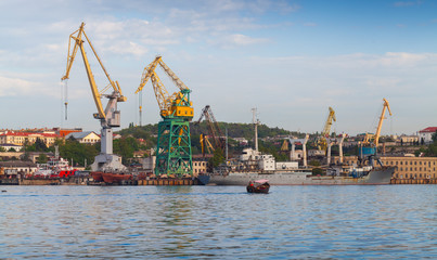 Sevastopol port, coastal cityscape with cranes